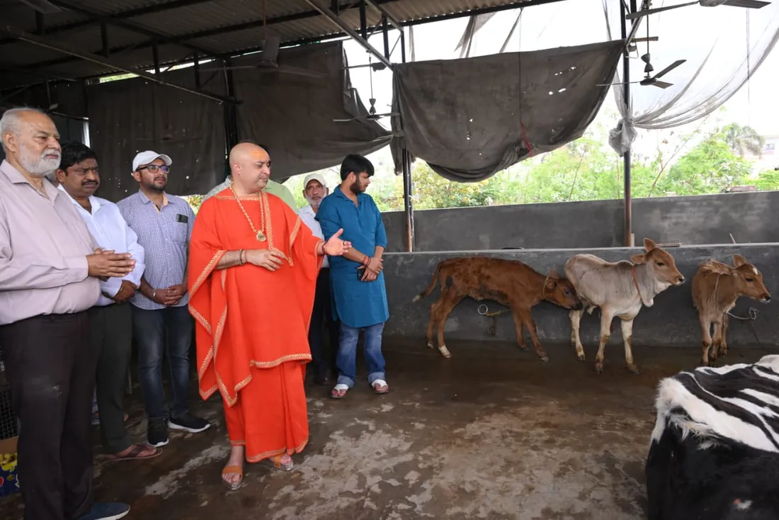 A visiting mahant and supporters meeting rescued calves at the shelter.